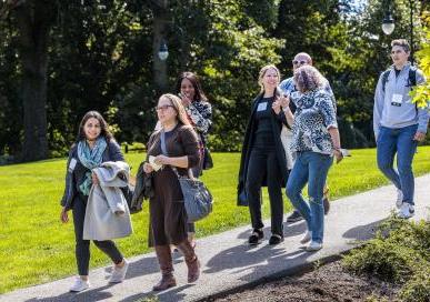 Alumnae walking down a path during Homecoming