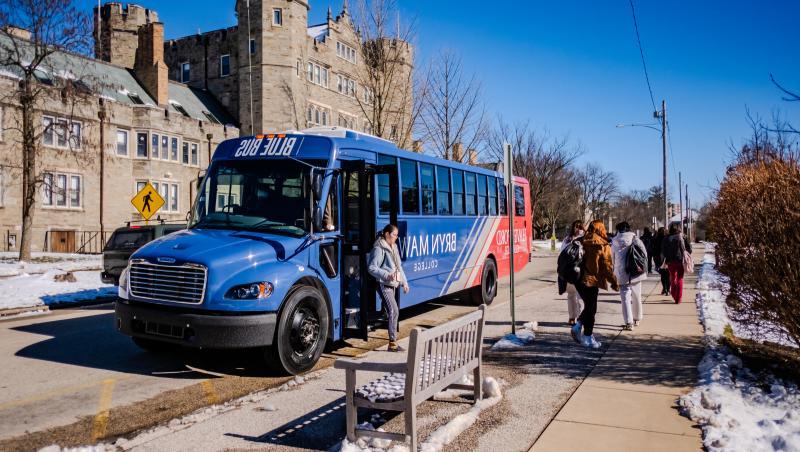 Students exit the electric bus by Pembroke Arch on Bryn Mawrs campus