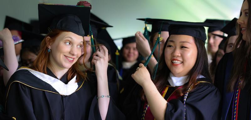 Two graduates at Commencement