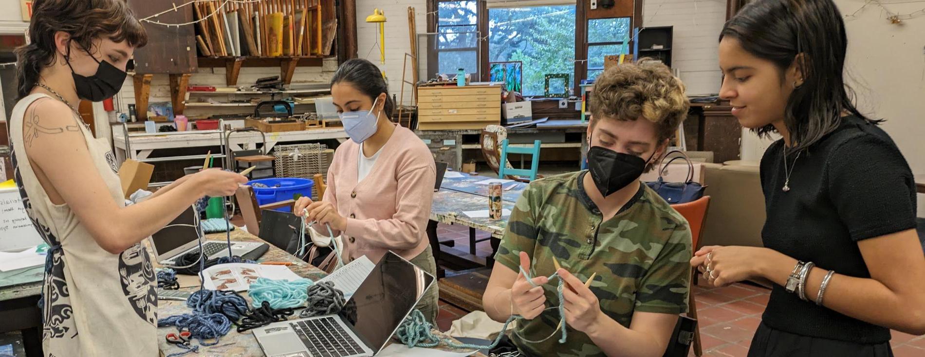 Students work on tapestries representing sulfur dioxide emissions from coal-fired power plants