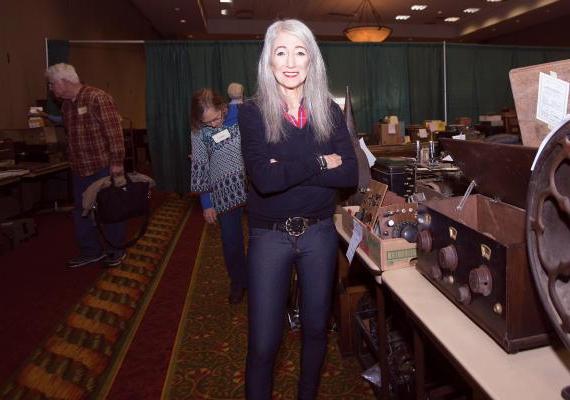 Barbara Kevles standing near vintage equipment